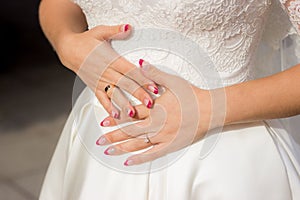 Wedding day. Bride in nice white dress holding her hands on belly