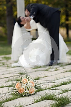 Wedding day dance, kisses and bouquet of flower