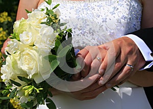 Wedding Day hands rings and bouquet