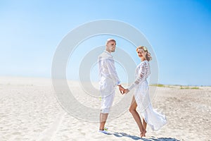 Wedding day. Happy young couple in love. Bride and groom on the beach