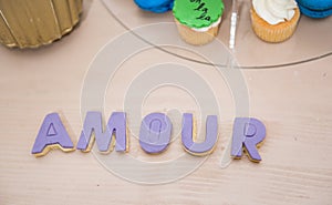 Wedding decor, AMOUR letters on table. AMOUR decoration on festive table. Luxurious wedding decoration on restaurant table