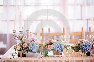 Wedding decor with candelabrum, blue and peach flowers