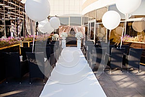 Wedding decor. Chairs for guests, wedding rings and huge white balloons