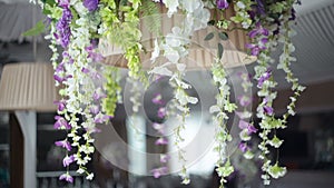 Wedding decor of flowers on a chandelier in a restaurant