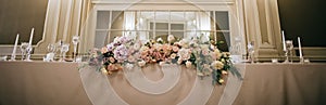 Wedding decor. Fresh bouquets of flowers on the table of the bride and groom at the restaurant