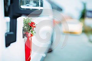 Wedding decor of limo handles. Flowers and grass on a car handle