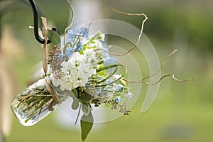 Wedding decor made with mason jar filled with white and blue flowers