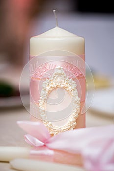 Wedding decor in pink style with crystals, lace, flowers and initials. Wedding candles for the family hearth.