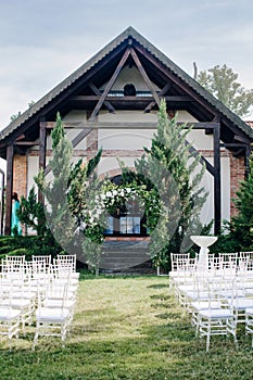 Wedding decor, a place for a wedding ceremony in nature, in the garden. Wedding arch made of fresh flowers, floristry.