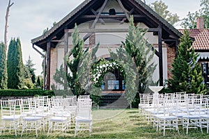 Wedding decor, a place for a wedding ceremony in nature, in the garden. Wedding arch made of fresh flowers, floristry.