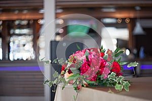 Wedding decor. Red Flowers in the restaurant, table setting