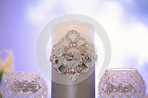 Wedding decor in silver style with crystals, lace and flowers. Wedding candles for the family hearth