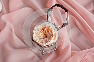 Wedding decor vintage glass square box with peony rose inside and wedding ring invitation card.