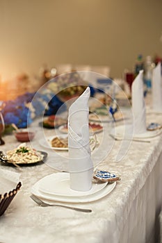 Wedding decor of white flowers on the table of the bride and groom in the restaurant