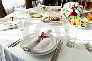 Wedding decorated table. Luxury light decor on table in restaurant