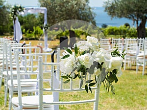 Wedding decoration chairs in rustic green style. Wedding ceremony outdoors
