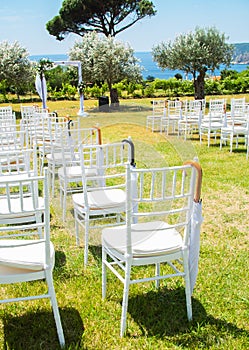 Wedding decoration chairs in rustic green style. Wedding ceremony outdoors