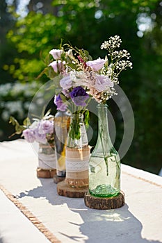 Wedding decoration of flowers in a bottle on the table