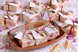 Wedding decoration guest favors handmade soaps in white and red colors original souvenirs on wood plate