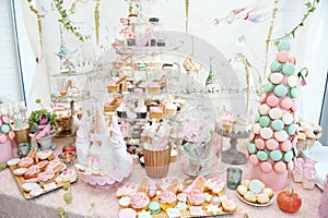 Wedding decoration with pastel colored cupcakes, meringues, muffins and macarons