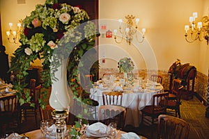 Wedding decoration on table. Floral arrangement and decoration. Arrangement of pink and white flowers in restaurant for event.