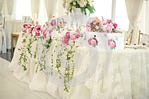 Wedding decoration on table. Floral arrangements and decoration. Arrangement of pink and white flowers in restaurant for event