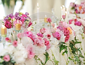 Wedding decoration on table. Floral arrangements and decoration. Arrangement of pink and white flowers in restaurant for event