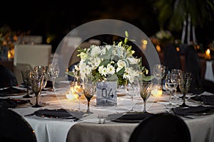 Wedding decoration on table. Floral arrangements and decoration. Arrangement of white flowers in restaurant for event.