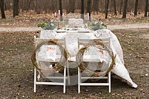 Wedding decoration table in the garden, floral arrangement, In the style vintage on outdoor served for two people.