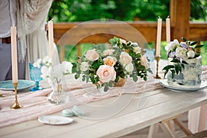 Wedding decoration table in the garden, floral arrangement, In the style vintage on outdoor. Wedding cake with flowers