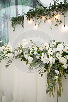 Wedding decoration table in the hall, floral arrangement. In the style vintage. Decorated dining table with flowers for