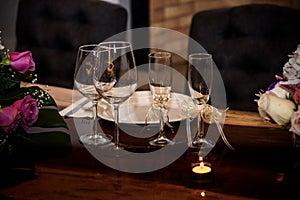 Small table flower purple luxury decoration with glass globets wedding event party at night, coctel table with candles photo