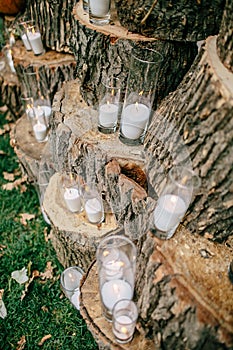Wedding decorations in rustic style. Outing ceremony. Wedding in nature. Candles in decorated goblets