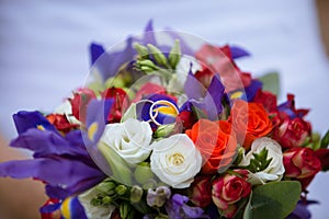 Wedding decorative bouquet of rose with two golden rings
