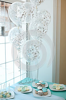 Wedding dessert table with cupcakes and balloons