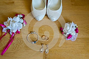 Wedding detail. Accessories for the bride. Shoes rings earrings bracelet and boutonniere