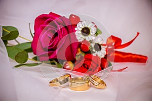 Wedding detail. boutonniere and three rings on the veil