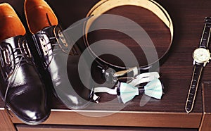Wedding details. Groom accessories. Shoes, rings, belt, and bowtie