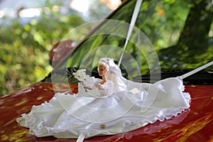 Wedding doll on car
