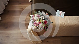 Wedding dress and bouquet lying on the bed, the bride is getting ready for the ceremony, women's accessories 2