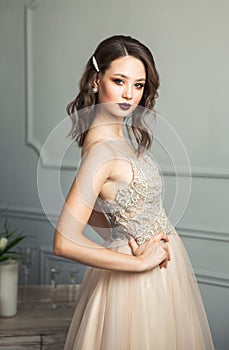 Wedding dress on fashion model. Delicate portrait of young model girl