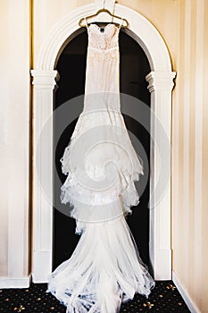 Wedding dress hanging on the door arch