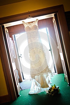 Wedding Dress Hanging in Doorway