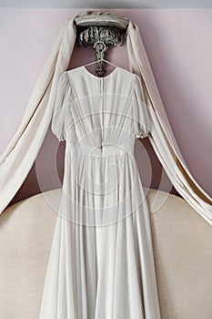 Wedding dress hanging over the bed