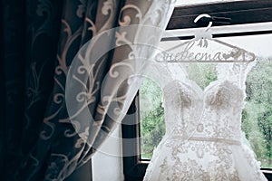 Wedding dress hanging on a window