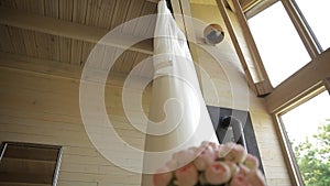 Wedding dress hanging on a wooden stairs of a two-story house