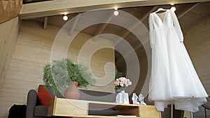 Wedding dress hanging on a wooden stairs of a two-story house