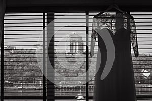 Wedding dress lace window overlooking city river