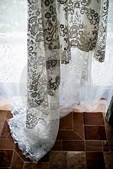 Wedding dress prepared for the bride. Wedding dress. White floral lace from a wedding dress. Details.