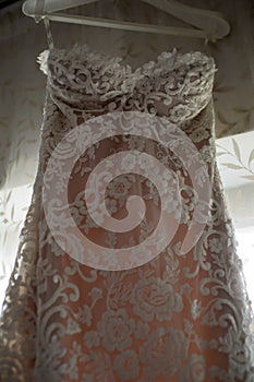 Wedding dress prepared for the bride. Wedding dress. White floral lace from a wedding dress. Details.
